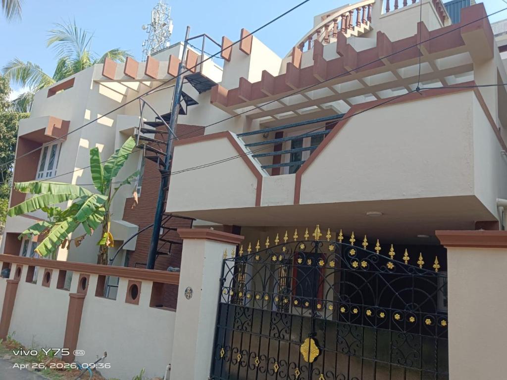 a house with a gate and a fence at Green Haven Villas in Chennai