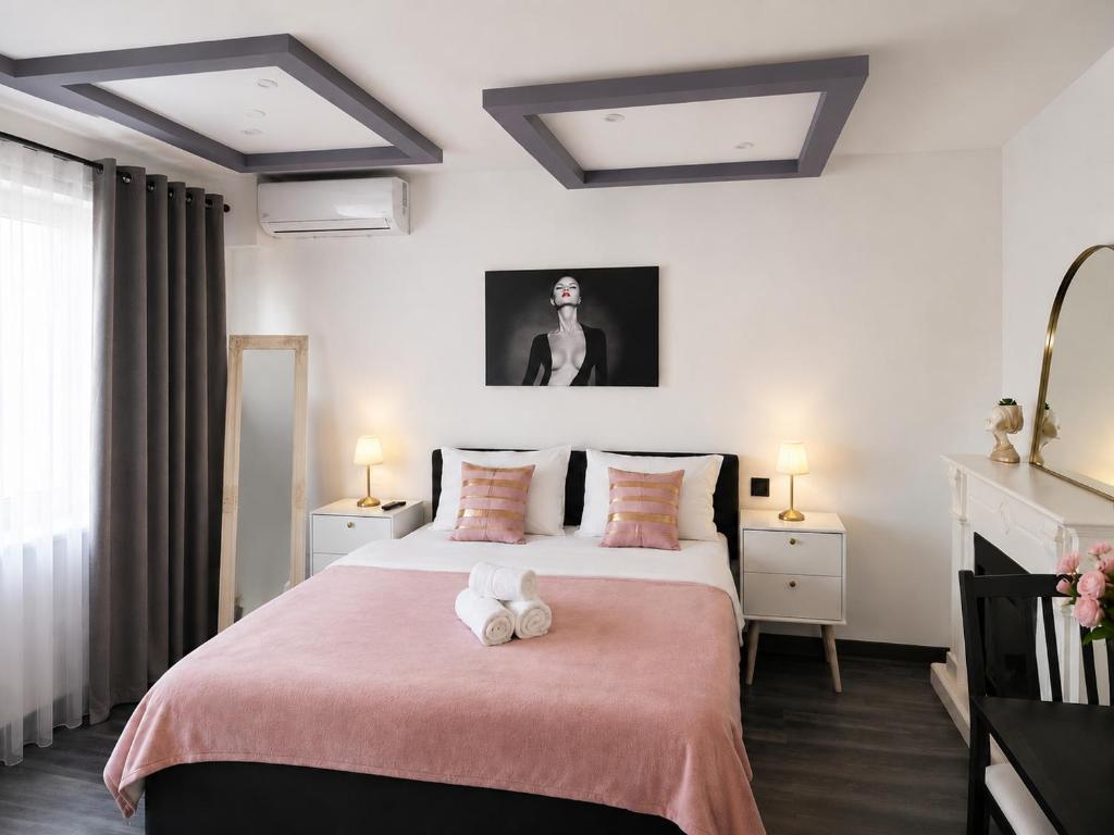 a bedroom with a bed with two stuffed animals on it at Hera Exclusive Stay in Timişoara