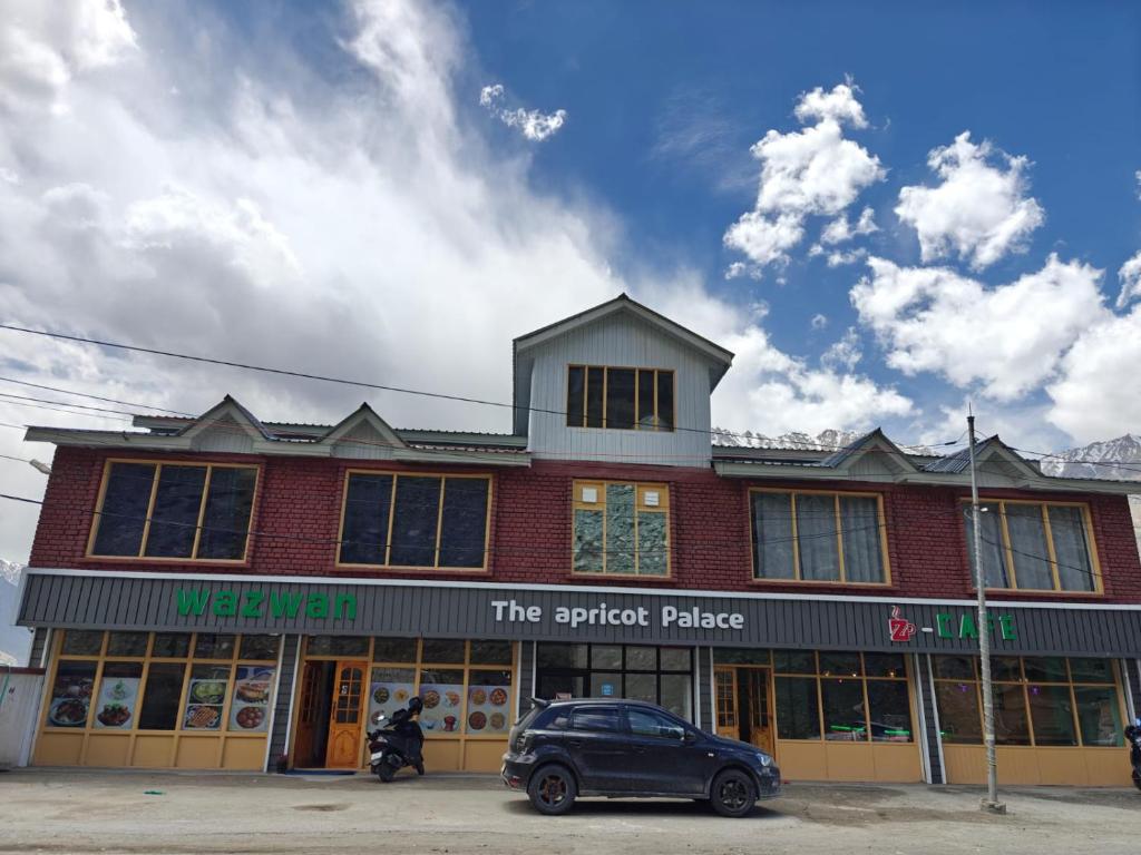 a building with a car parked in front of it at The Apricot Palace in Kargil