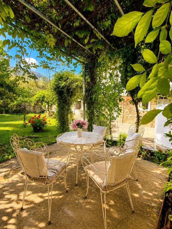 a table and chairs sitting under a pergola at Acheron House in Gliki