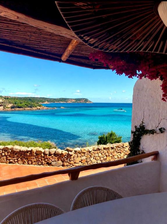 a view of the ocean from a resort balcony at Princes Apartment PortoCervoBEACH con accesso diretto in spiaggia Piccolo Pevero in Porto Cervo