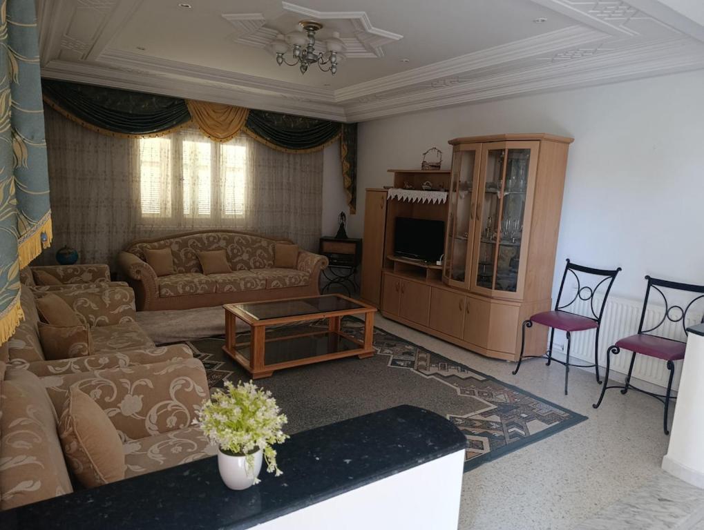 a living room with a couch and a table at Cozy house in Nabeul