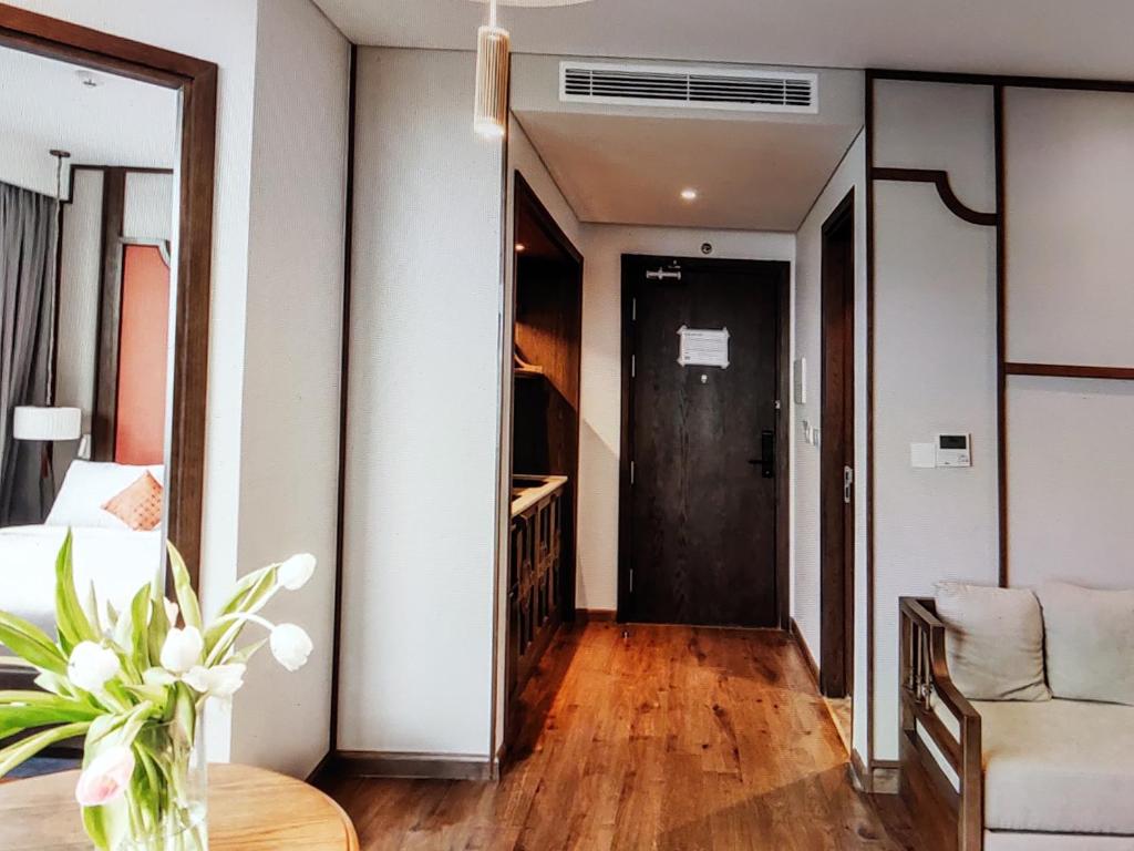 a living room with a door leading to a bedroom at Pristine Coast Residences in Phan Thiet