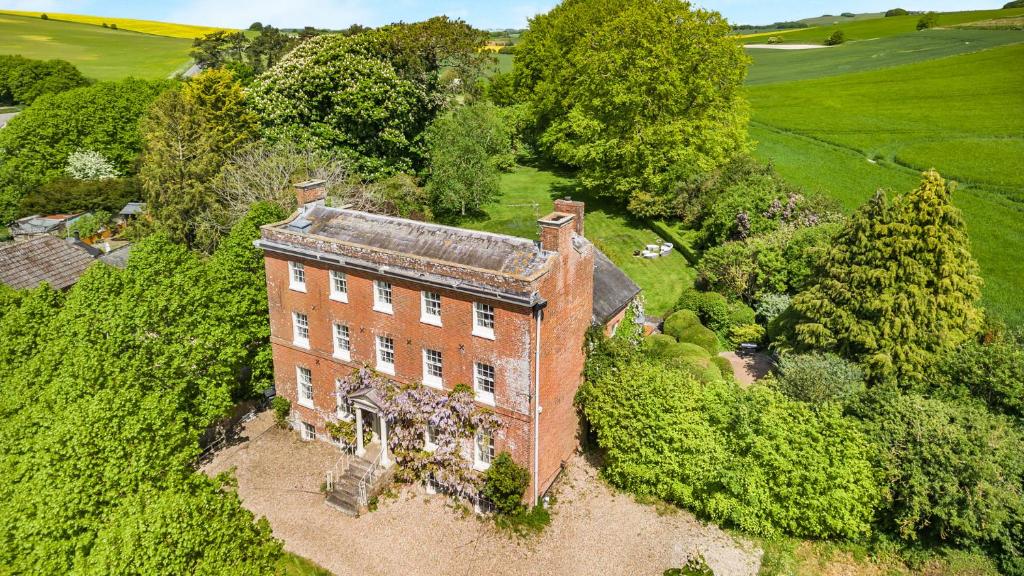 an aerial view of an old brick house at West Kennett House in Marlborough
