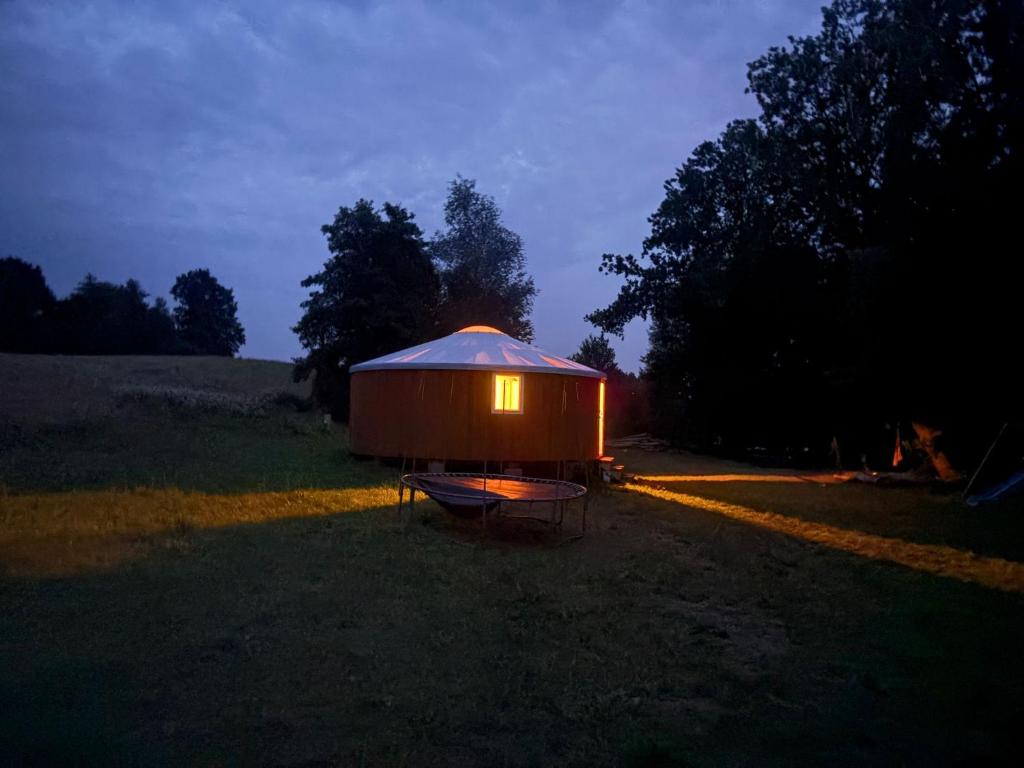a small tent in a field at night at Helagust in Dołgie