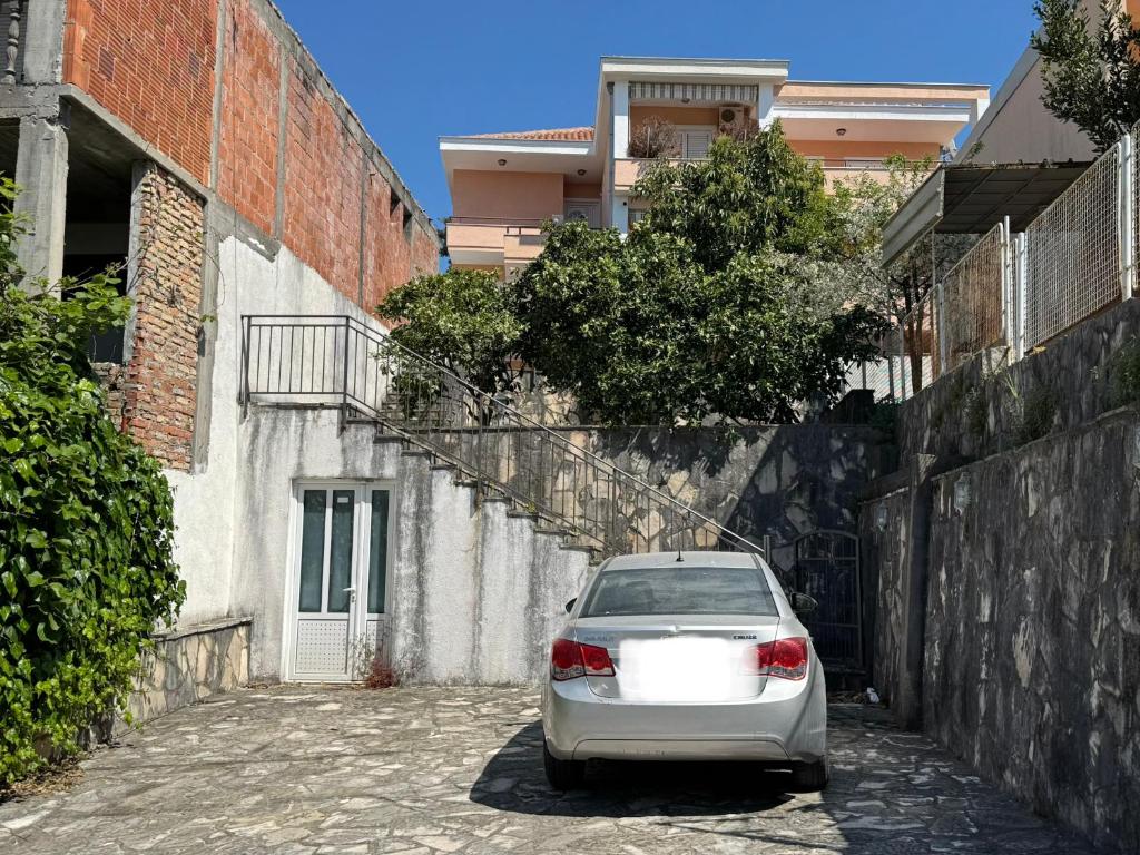 a white car parked in a alley next to a building at SS Pearl Apartment 1 in Utjeha
