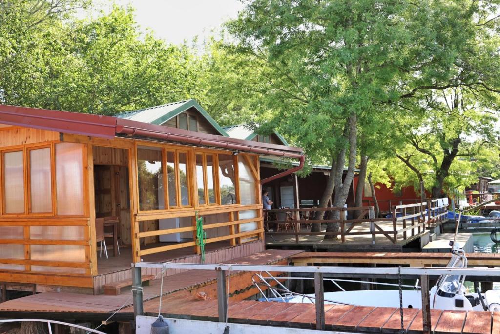 a house being constructed on a dock with trees at Kucica Enterprise-Ada Bojana in Ulcinj