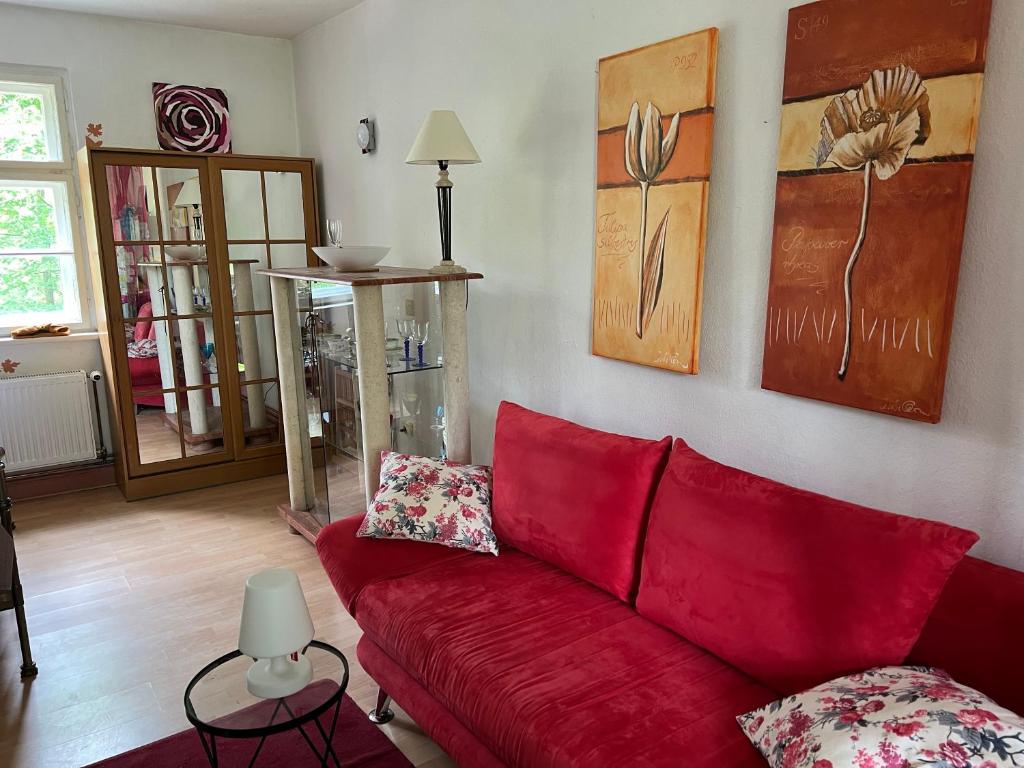 a red couch sitting in a living room at Radstation Menz in Menz