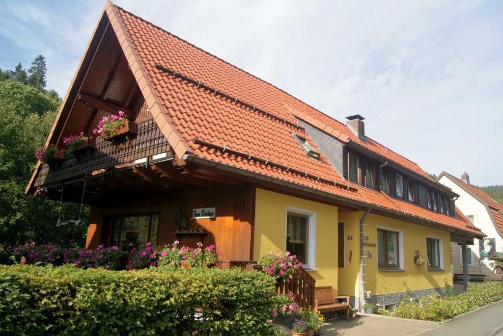 a yellow house with an orange roof at Pension Haus Brückner in Wildemann