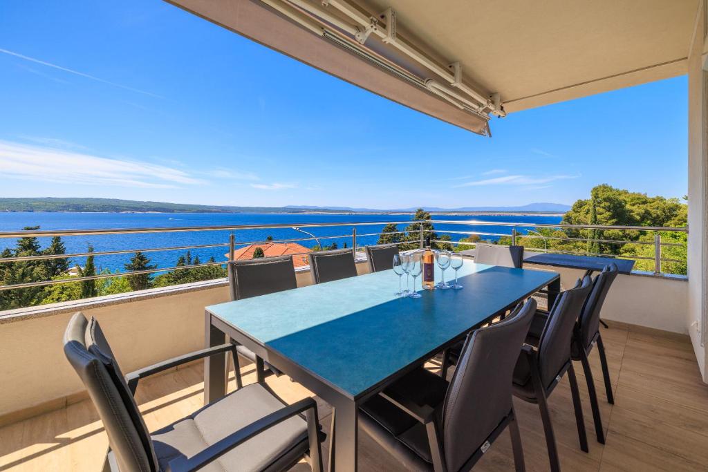 a dining room with a table and chairs on a balcony at Melanie in Crikvenica
