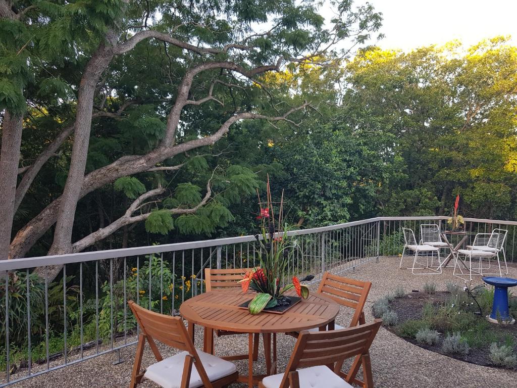 a patio with a table and chairs and a fence at "Casa Serena" - Spacious Entire Holiday Home in Caboolture