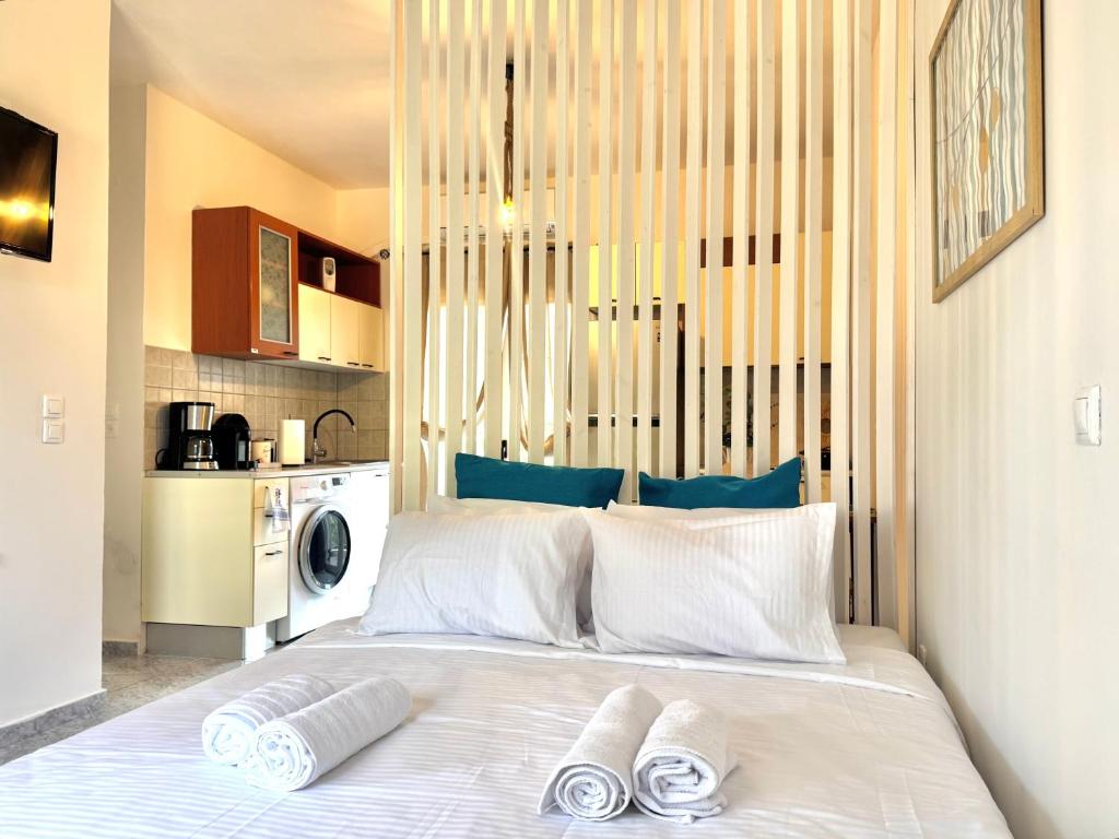 a bedroom with a bed with two towels on it at Rocky Stays - Argostoli Central Studio in Argostoli