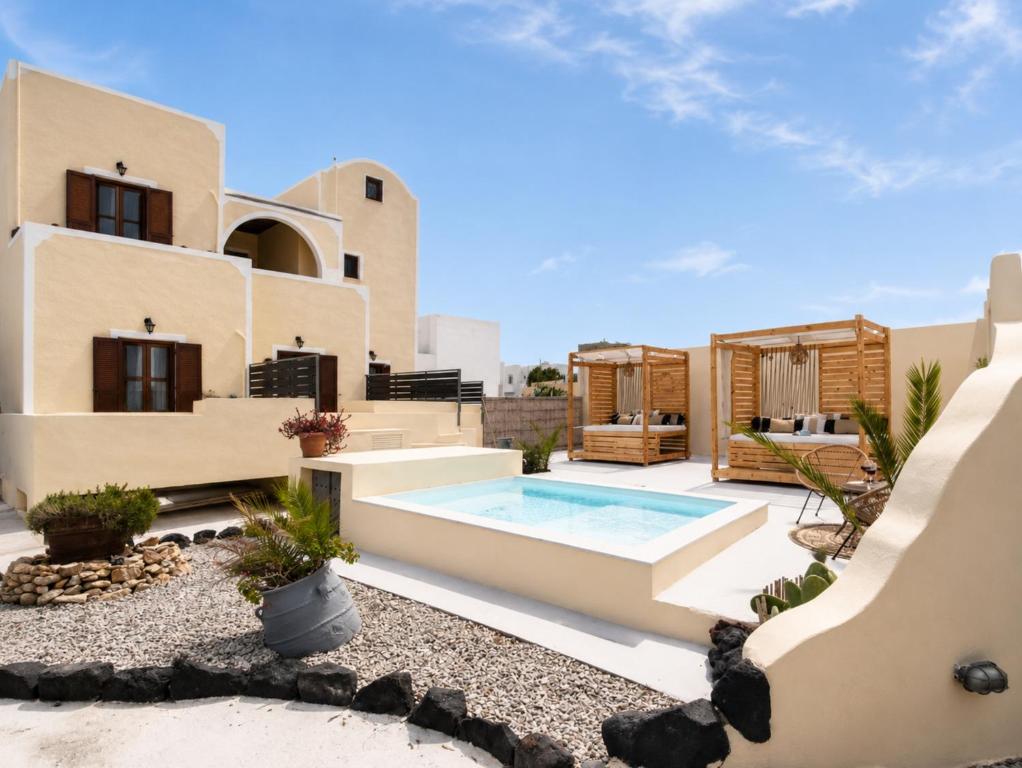 a house with a swimming pool in front of it at Marina's Studios in Perivolos