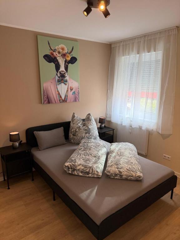 a bedroom with a bed with a cow head on the wall at S22 Living in Weingarten (Karlsruhe)
