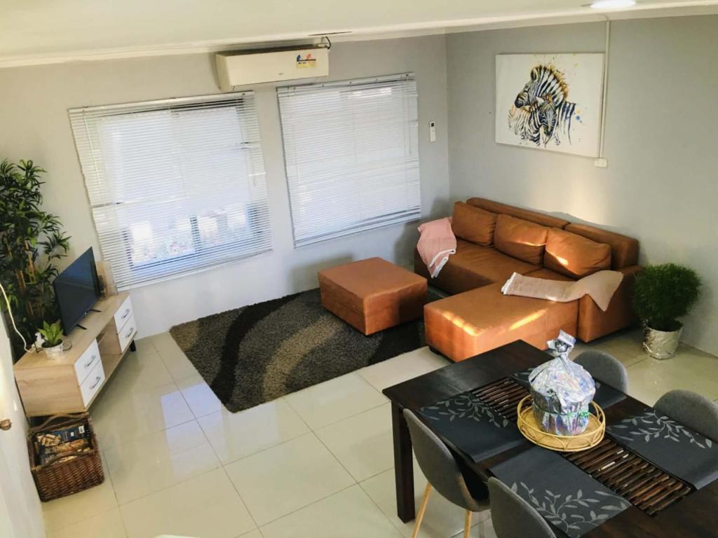 a living room with a couch and a table at BOU's Accomodation in Nadi