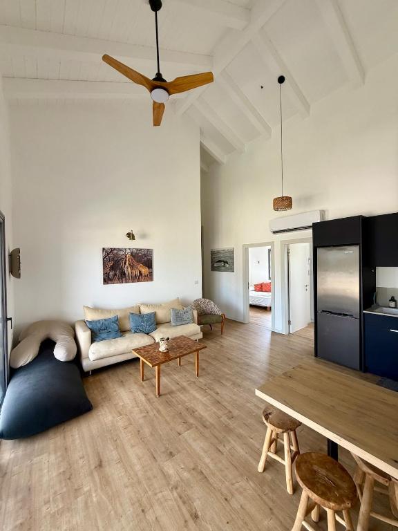 a living room with a couch and a table at שחף על הכנרת in HaOn