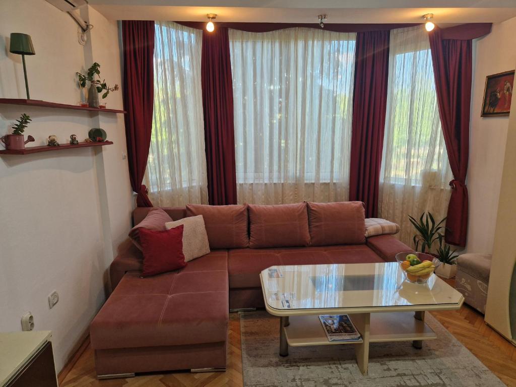 a living room with a couch and a glass table at Velvet Nest in Kumanovo