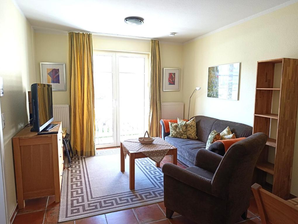 a living room with a couch and a tv at Hermannstr 14-Whg 10 in Kühlungsborn