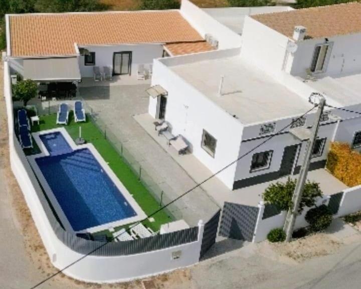an aerial view of a house with a swimming pool at Casas Caiado Two Houses with swimming POOL in Faro