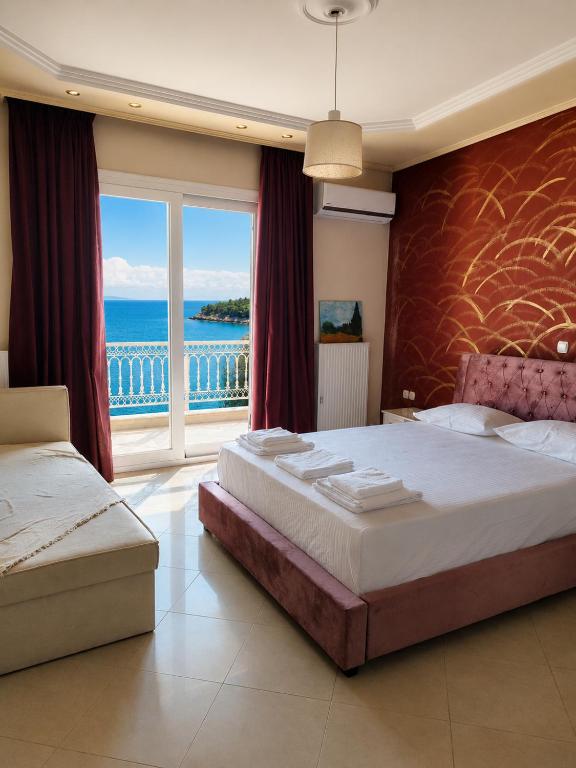 a bedroom with two beds and a view of the ocean at Sunshine in Skala Marion