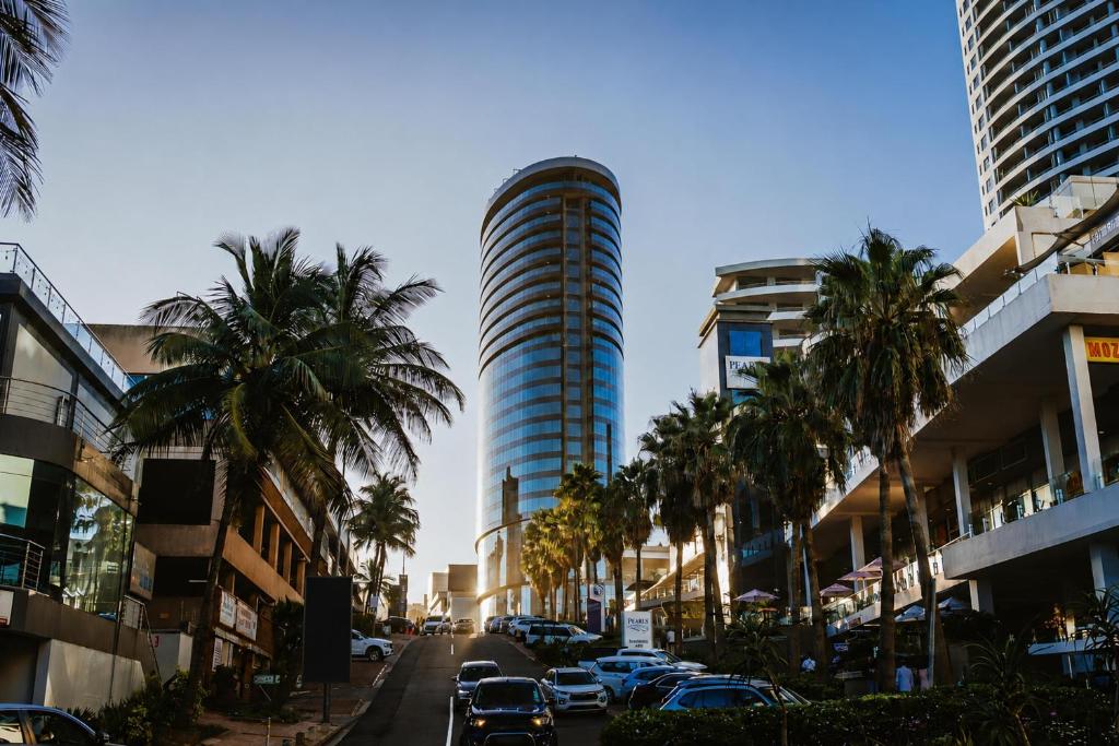a city street with palm trees and a tall building at Radisson Blu Hotel, Durban Umhlanga in Durban