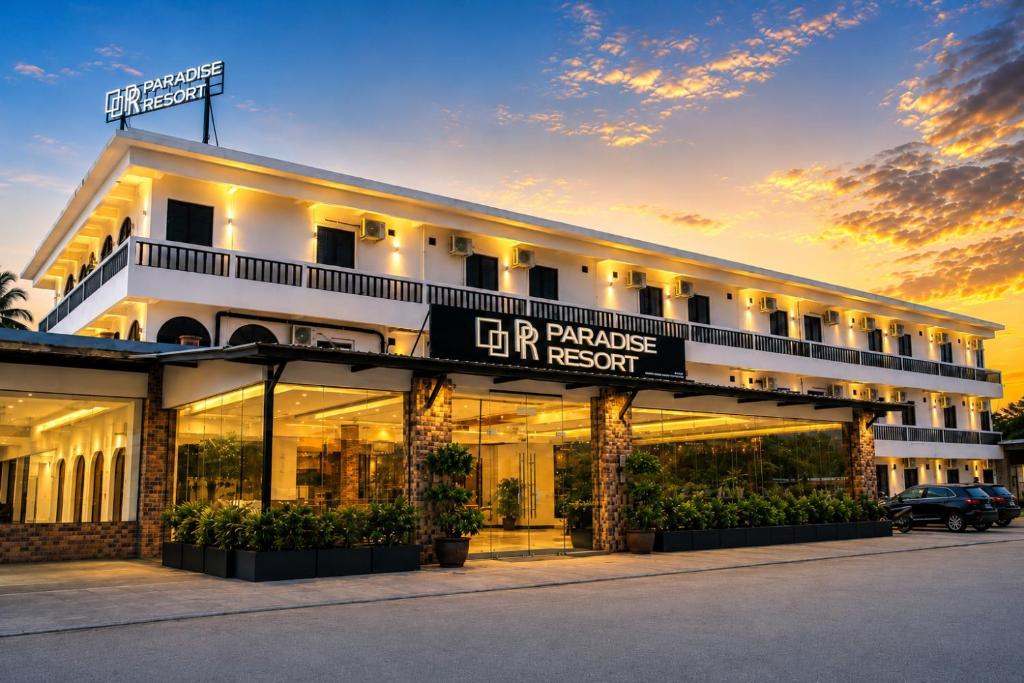 a hotel with a sign on the front of it at Paradise Resort Langkawi in Pantai Cenang