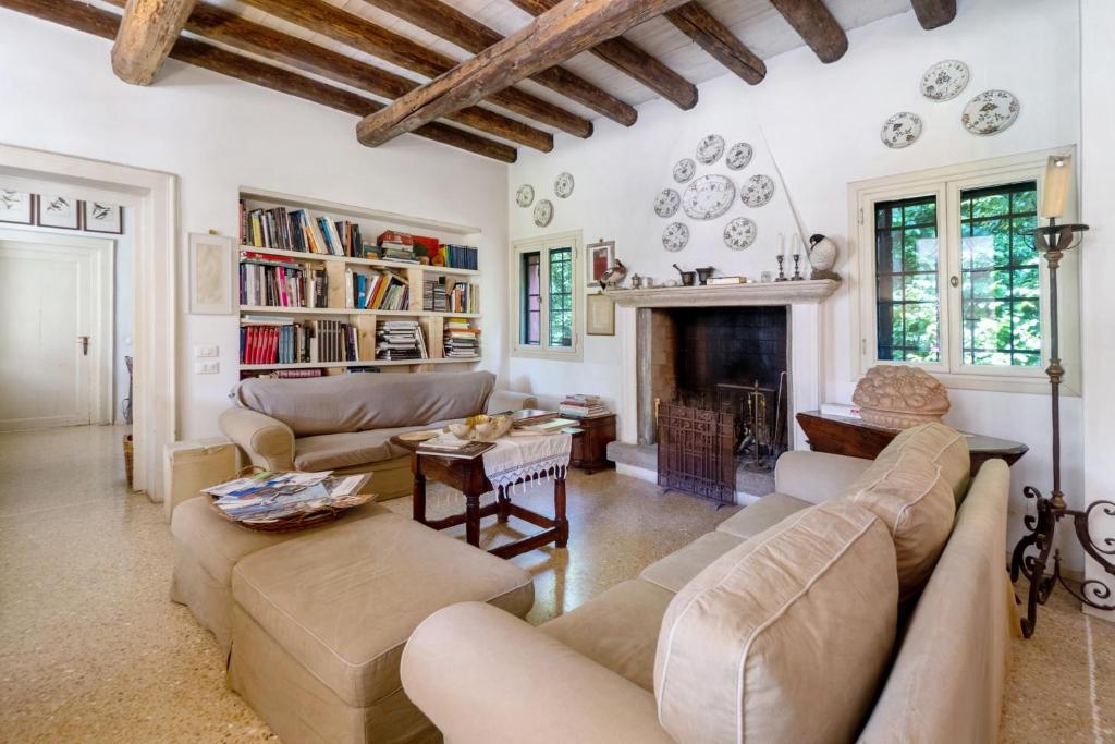 a living room with couches and a fireplace at Villa Colloredo in Dolo