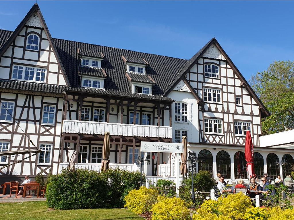 a large building with people sitting outside of it at Hotel Hiddensee Hitthim in Kloster