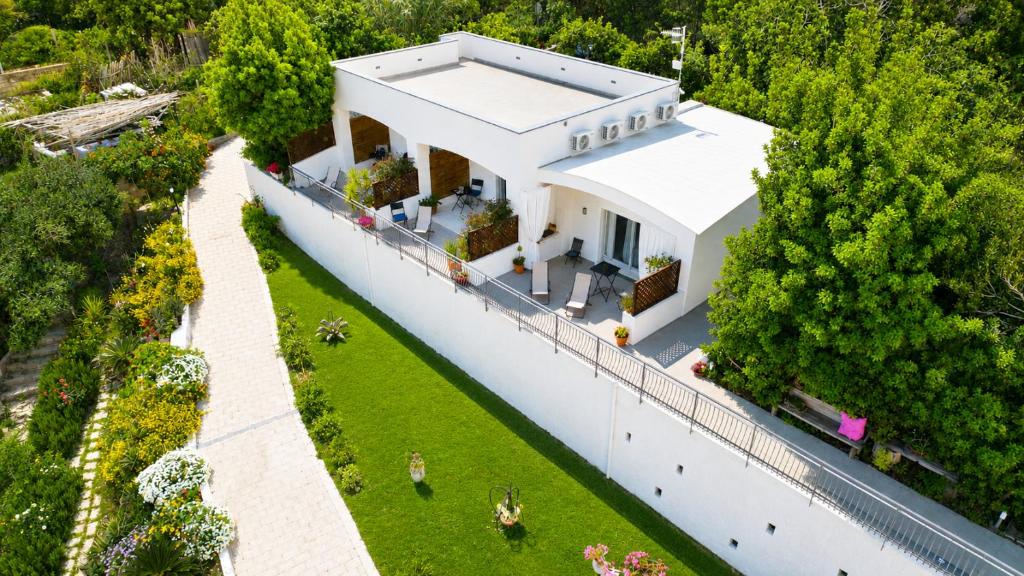 an aerial view of a white house with a garden at La caccetta in Procida