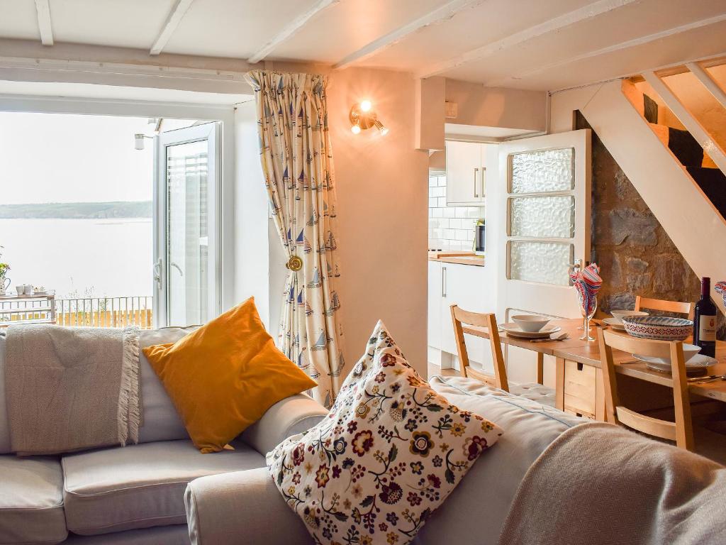 a living room with a couch and a table at Seadrift in New Quay