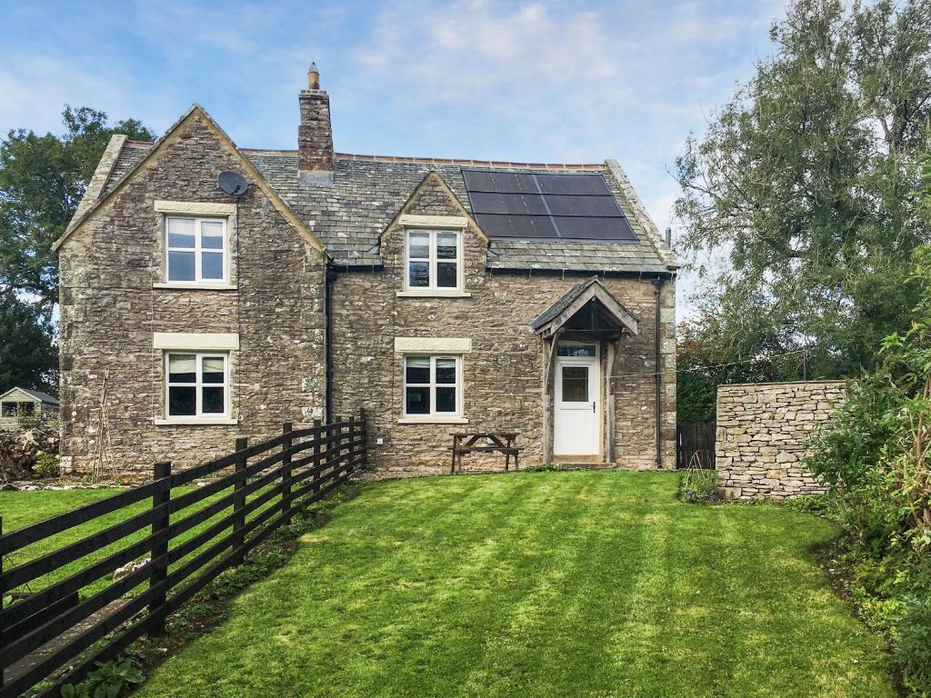 a house with solar panels on the roof at Smardale Cottage in Kirkby Stephen