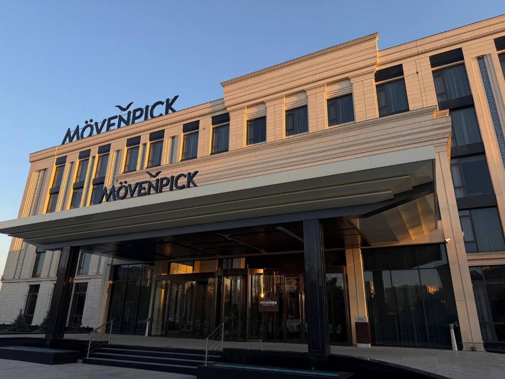a building with a sign on top of it at MOVENPICK TASHKENT OLD CITY in Tashkent