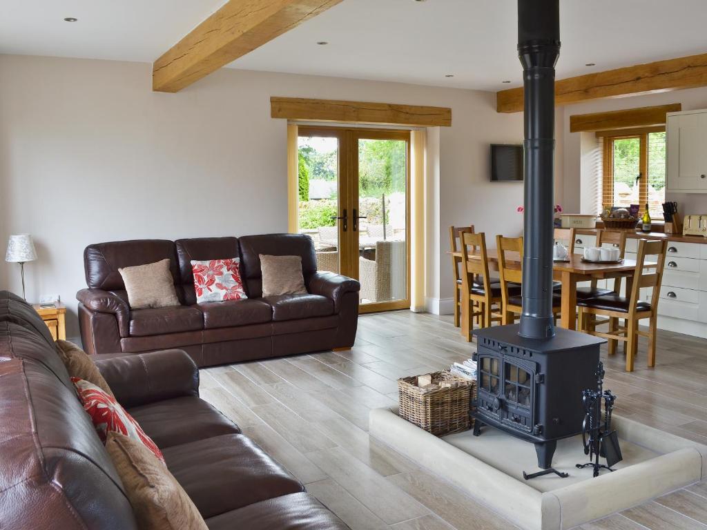 a living room with a wood stove in it at The Granary in Pendleton