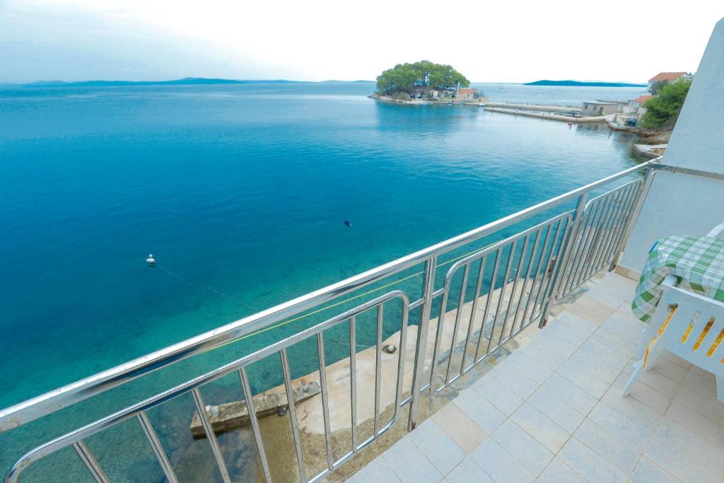 a balcony with a view of a body of water at Apartmani Sime in Savar