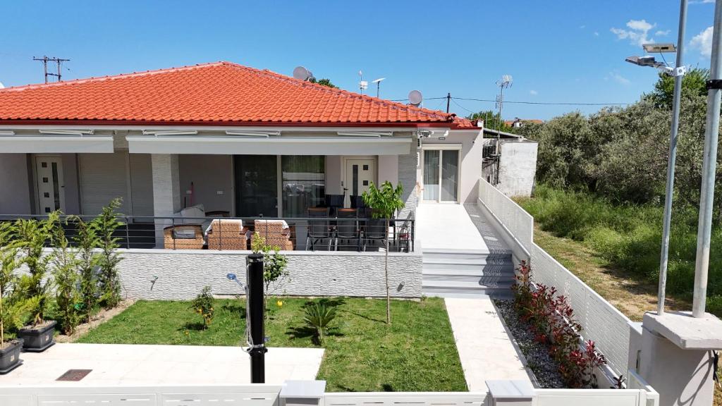 a white house with an orange roof at Veranda White in Nea Vrasna