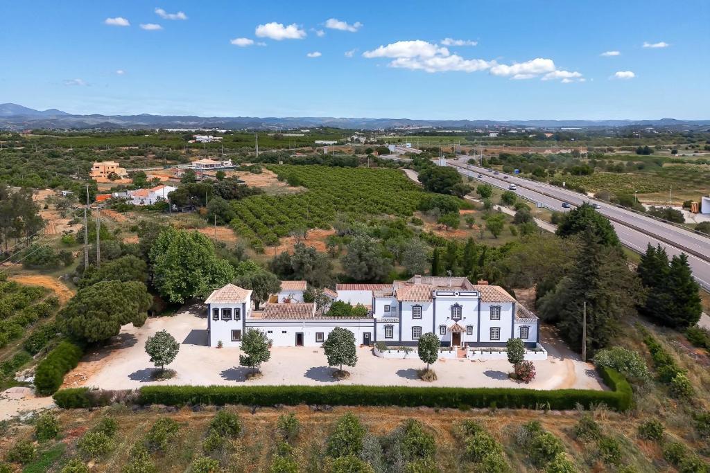an aerial view of a large white house with a road at Quinta de Loubite by Sweethomes in Lagoa