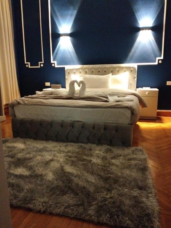 a bedroom with a bed with a mirror and a rug at Cairo Center in Cairo