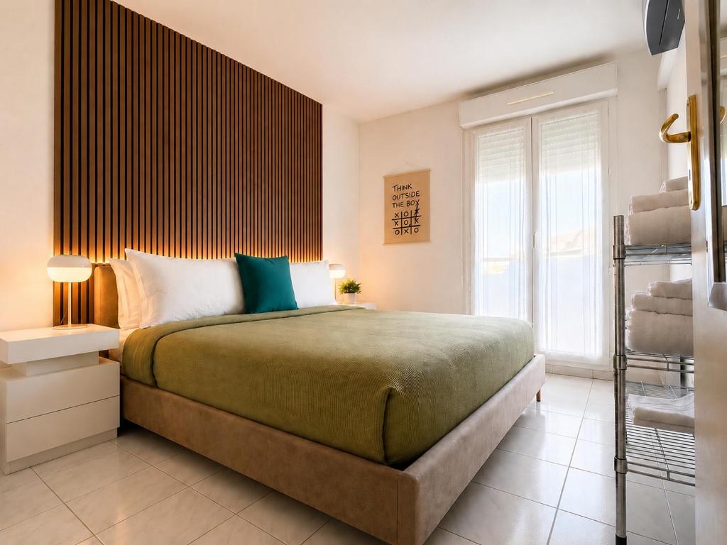 a bedroom with a large bed and a window at La Terrasse Bleue-Parking couvert-2 min plage-Juan Les Pins in Antibes