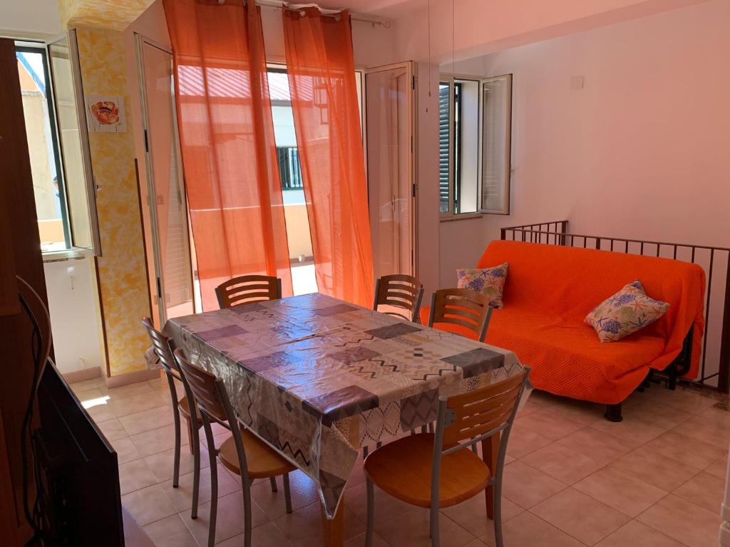 a living room with a table and a couch at Delfino in Letojanni