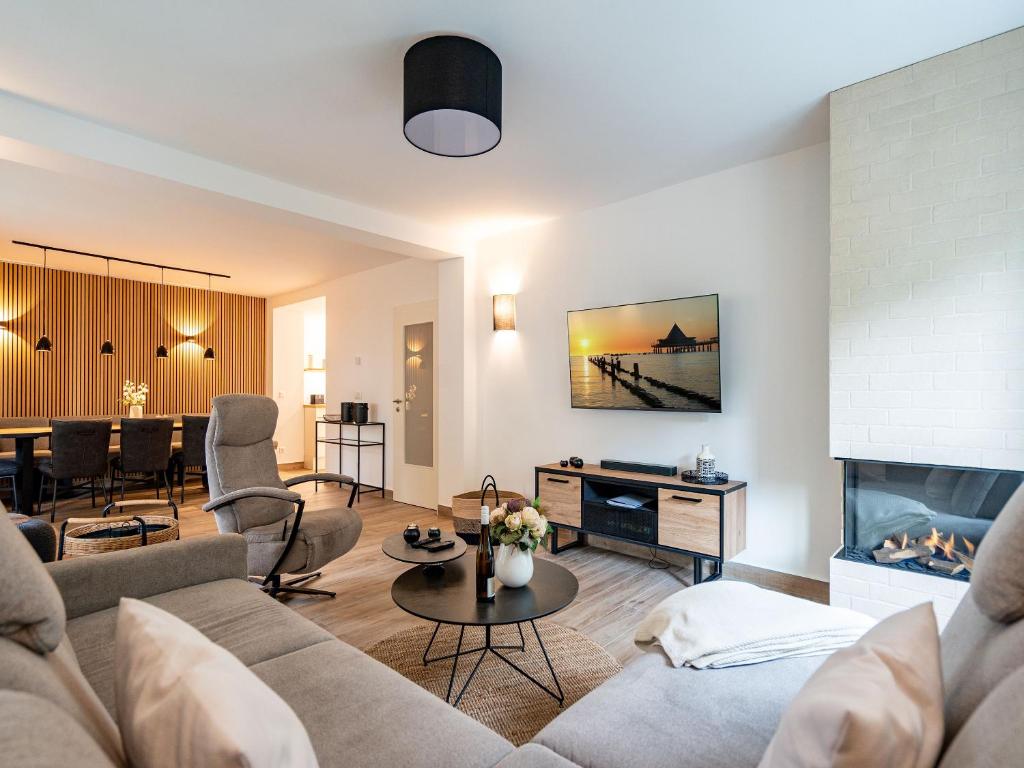 a living room with a couch and a fireplace at Ferienhaus Amica in Heringsdorf