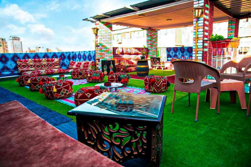 a group of chairs and tables on a patio at Castle hostel in Cairo