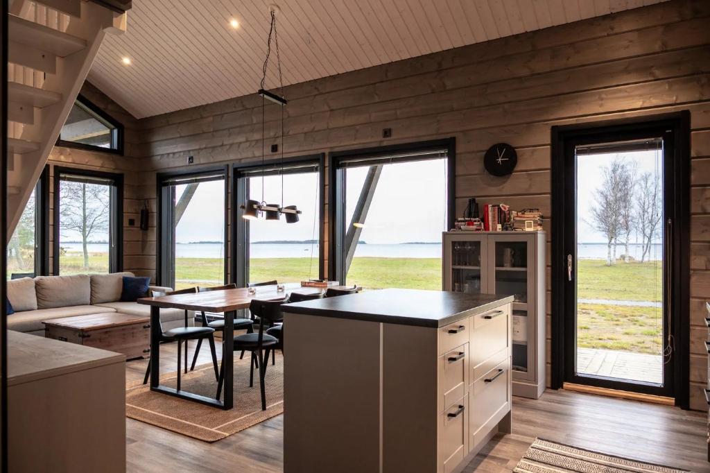 a kitchen and living room with a table and a couch at Sea Haven Villa in Trutberget