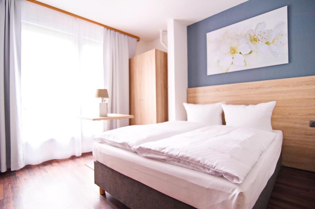 Postel nebo postele na pokoji v ubytování BlnCty Hotel