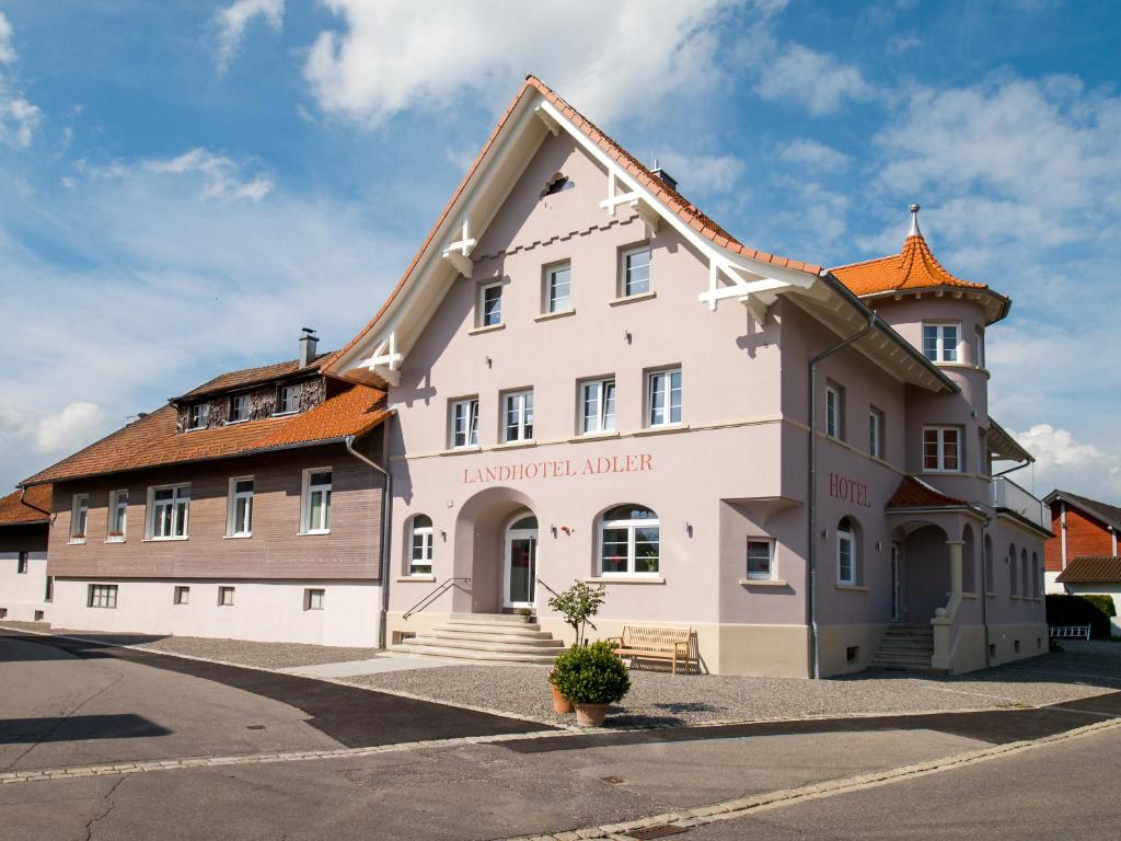 a large white building with an orange roof at Landhotel Adler in Sigmarszell