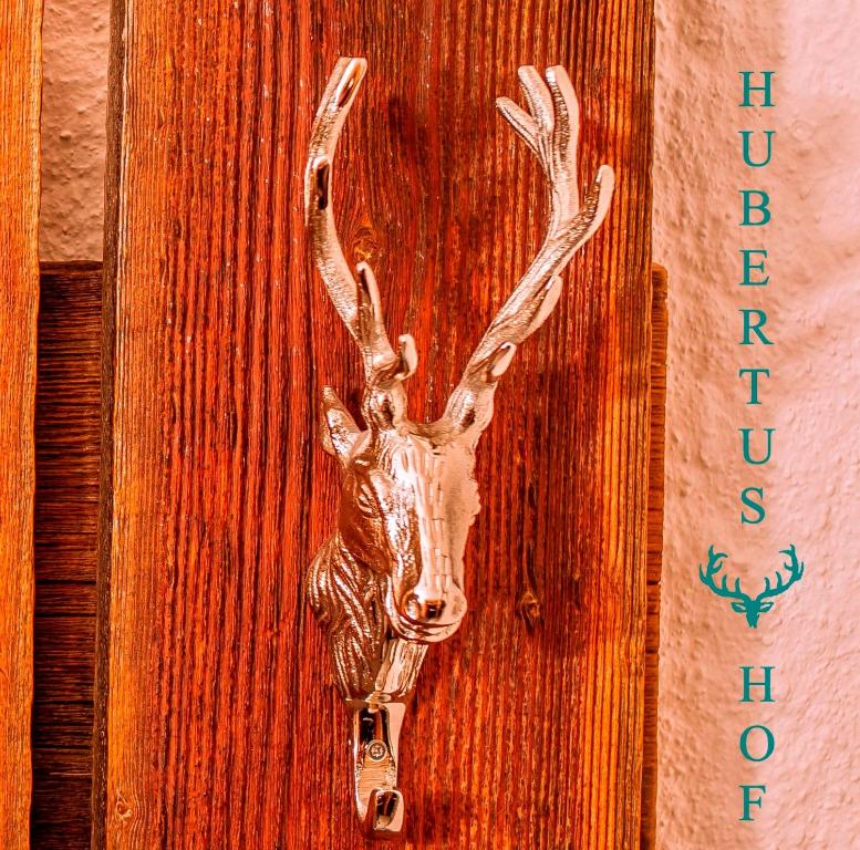 a door with a reindeer head hanging on it at Hubertushof in Jungholz