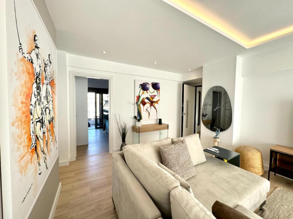 a living room with a couch and a tv at Alimos Escape 3 in Athens