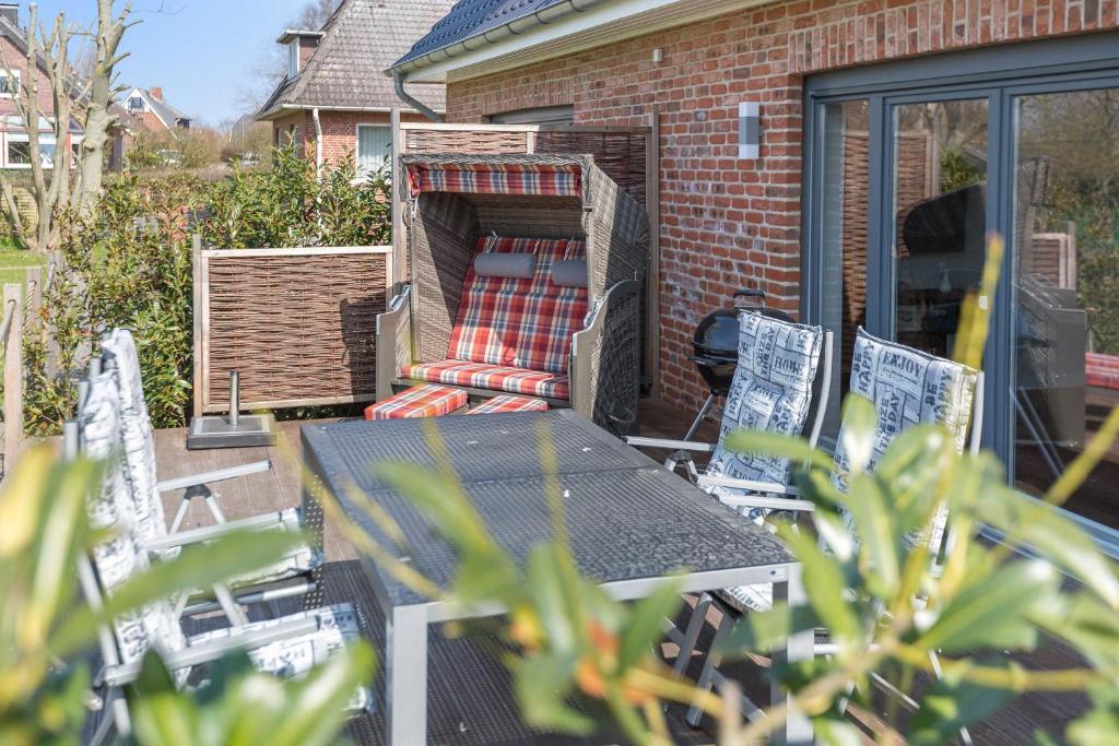 a patio with a table and chairs and a blanket at Fehmarn in List