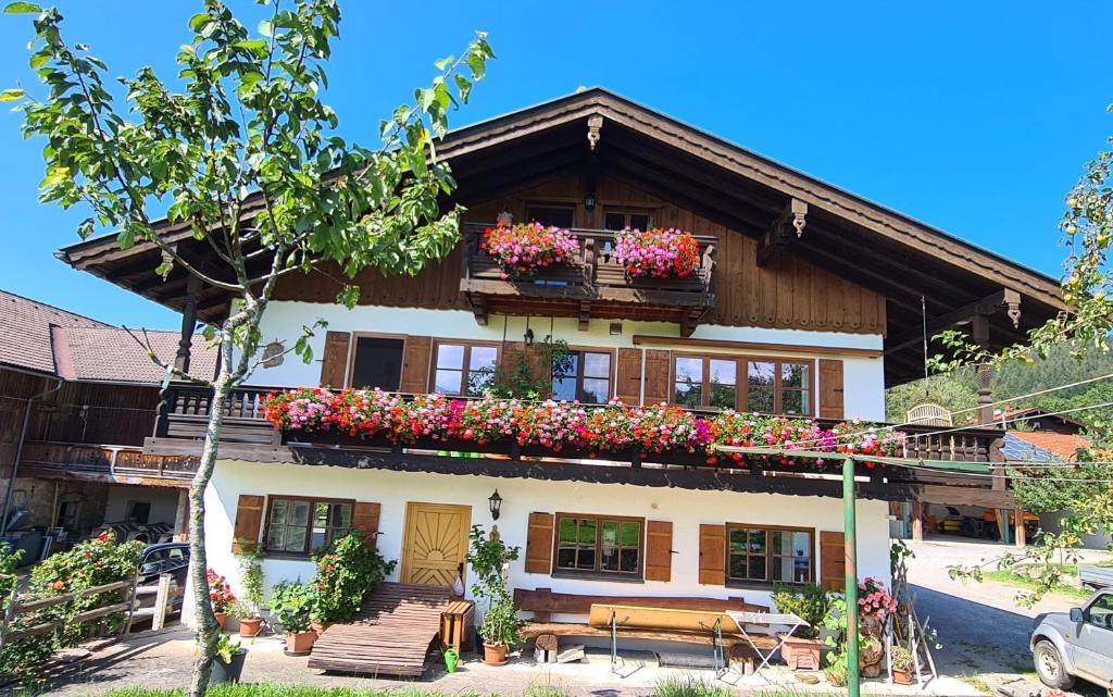 a building with flower boxes on the side of it at Maria Schnitzenbaumer in Fischbachau
