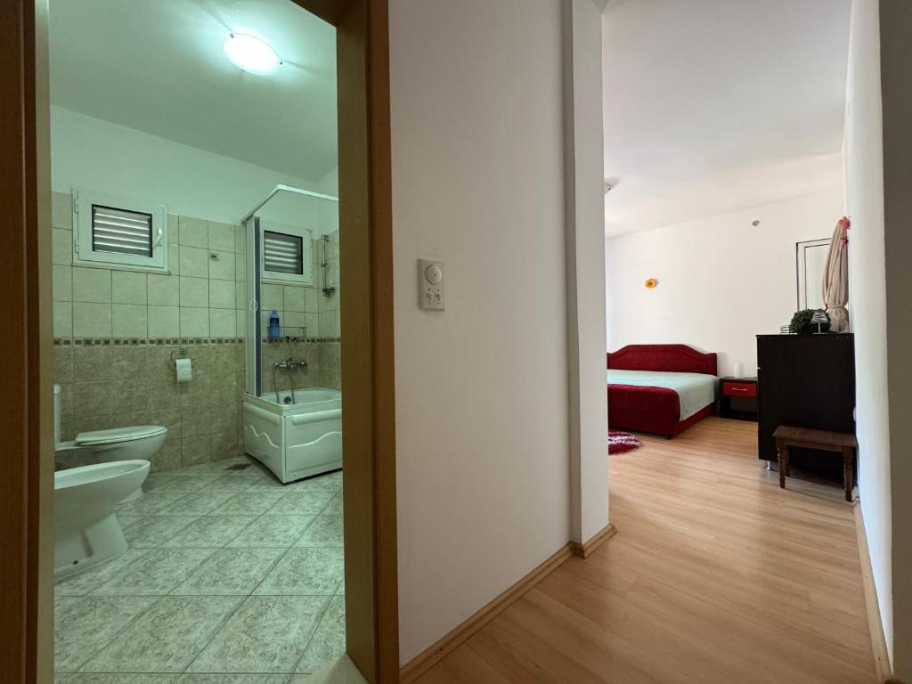 a bathroom with a toilet and a sink and a tub at S Pearl Lux in Utjeha