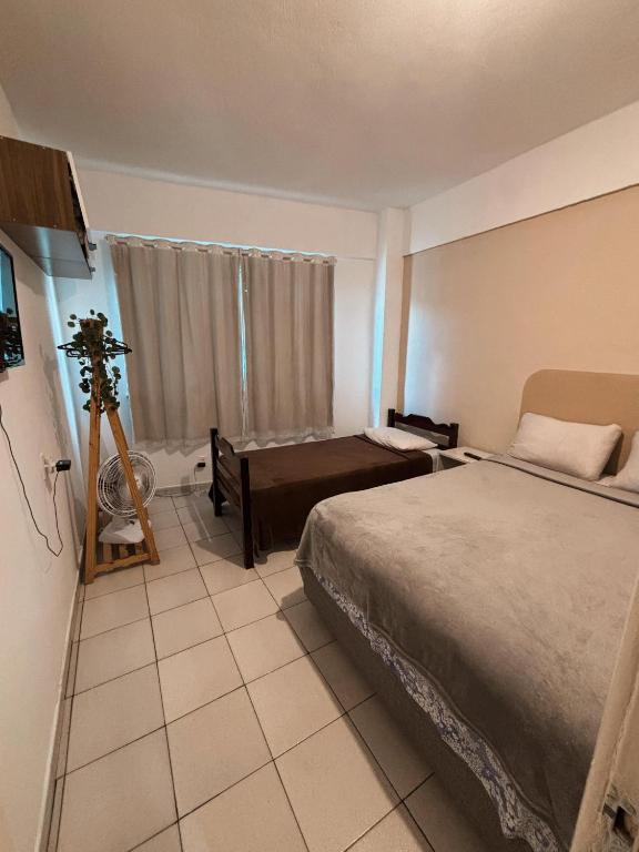 a hotel room with a bed and a camera at Apartamento Rua Teresa in Petrópolis